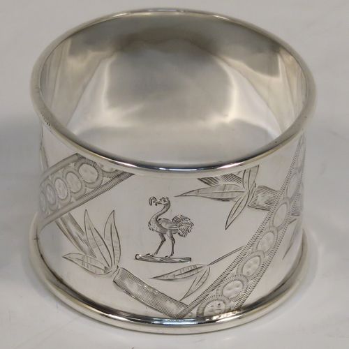 A very pretty Antique Victorian Sterling Silver pair of napkin rings, in an Aesthetic style having round straight-sided bodies with hand-engraved bamboo and butterfly decoration, and all in their original maroon satin and velvet-lined presentation box. These beautiful antique silver Aesthetic style napkin rings were made by Martin Hall and Co., of Sheffield in 1887. The dimensions of these fine hand-made antique silver napkin rings are diameter 4 cms (1.5 inches), height 3 cms (1 inch), and they weigh a total of approx. 34g (1 troy ounce).