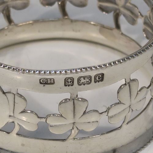 A pretty Antique Edwardian Sterling Silver set of six napkin rings, having round straight-sided bodies, with hand-pierced three-leaf clover Shamrock style decoration, and with bead borders, all in their original dark-blue satin and velvet-lined presentation box. These beautiful silver napkin rings were made by Charles Horner of Birmingham in 1902. The dimensions of these fine hand-made silver napkin rings are diameter 4.5 cms (1.75 inches), height 2.5 cms (1 inch), and they weigh a total of approx. 95g (3.6 troy ounces).