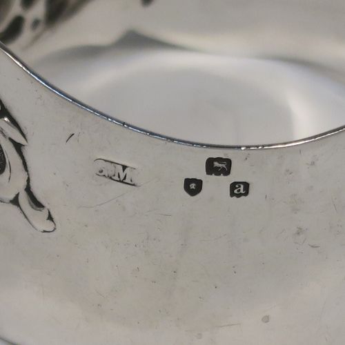 A very pretty Antique Victorian Sterling Silver pair of napkin rings, having round straight-sided bodies with hand-chased floral and scroll decoration surrounding an oval vacant cartouche on one side, all in their original cream satin and dark blue velvet-lined presentation box. These beautiful antique silver napkin rings were made by George Maudsley Jackson of London in 1898. The dimensions of these fine hand-made antique silver napkin rings are diameter 4.5 cms (1.75 inches), height 3 cms (1 inches), and they weigh a total of approx. 56g (1.8 troy ounces).