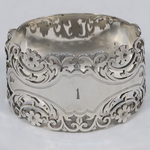 A very pretty and heavy Antique Victorian Sterling Silver pair of napkin rings, having oval straight-sided bodies with hand-pierced and engraved floral and scroll decoration, all in their original cream satin and dark blue velvet-lined presentation box. These beautiful antique silver napkin rings were made by Alexander Clarke of Sheffield in 1901. The dimensions of these fine hand-made antique silver napkin rings are length 6 cms (2.25 inches), height 3.5 cms (1.3 inches), and they weigh a total of approx. 93g (3 troy ounces). Please note that these napkin rings are numbered one and two.