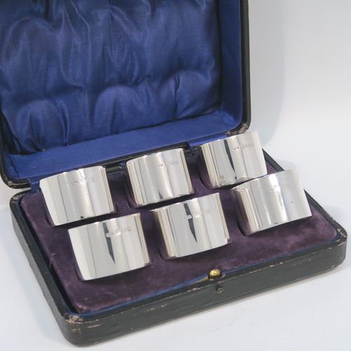 A very handsome Sterling Silver set of six napkin rings, having plain round bodies with straight sides, all in their dark blue satin and velvet-lined presentation box. These elegant silver napkin rings were made by Docker and Burn Ltd., of Birmingham in 1929. The dimensions of these fine hand-made silver napkin rings are diameter 4 cms (1.5 inches), height 3 cms (1.25 inches), and they weigh a total of approx. 187g (6 troy ounces).  