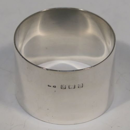 A very handsome Sterling Silver set of six napkin rings, having plain round bodies with straight sides, all in their dark blue satin and velvet-lined presentation box. These elegant silver napkin rings were made by Docker and Burn Ltd., of Birmingham in 1929. The dimensions of these fine hand-made silver napkin rings are diameter 4 cms (1.5 inches), height 3 cms (1.25 inches), and they weigh a total of approx. 187g (6 troy ounces).