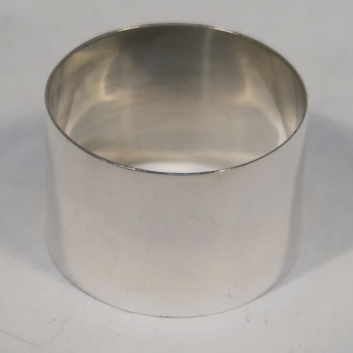 A very handsome Sterling Silver set of six napkin rings, having plain round bodies with straight sides, all in their dark blue satin and velvet-lined presentation box. These elegant silver napkin rings were made by Docker and Burn Ltd., of Birmingham in 1929. The dimensions of these fine hand-made silver napkin rings are diameter 4 cms (1.5 inches), height 3 cms (1.25 inches), and they weigh a total of approx. 187g (6 troy ounces).