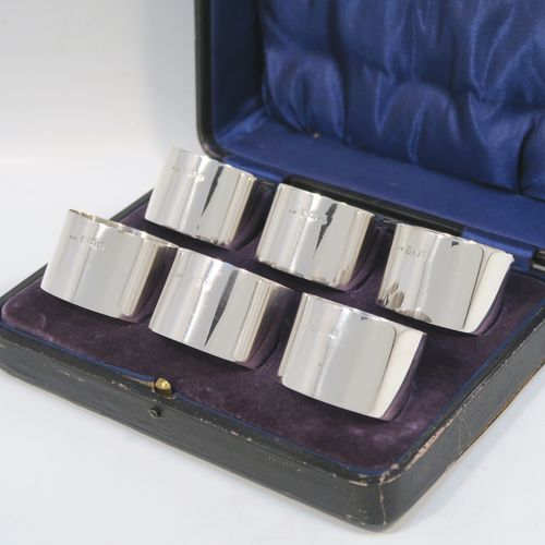 A very handsome Sterling Silver set of six napkin rings, having plain round bodies with straight sides, all in their dark blue satin and velvet-lined presentation box. These elegant silver napkin rings were made by Docker and Burn Ltd., of Birmingham in 1929. The dimensions of these fine hand-made silver napkin rings are diameter 4 cms (1.5 inches), height 3 cms (1.25 inches), and they weigh a total of approx. 187g (6 troy ounces).