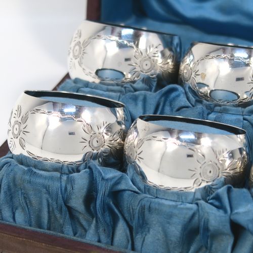 A set of six Antique Sterling Silver napkin rings, having round bellied bodies with hand-engraved floral decoration surrounding vacant cartouches, all in their original light blue satin-lined presentation box. This beautiful set of silver napkin rings were made by Joseph Gloster of Birmingham 1913. The dimensions of these fine hand-made antique silver napkin rings are diameter 5 cms (2 inches), height 2.5 cms (1 inch), and they weigh a total of approx. 107g (3.5 troy ounces).
