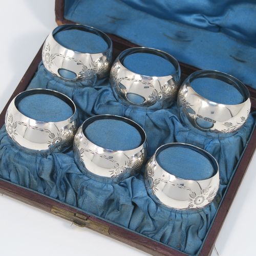 A set of six Antique Sterling Silver napkin rings, having round bellied bodies with hand-engraved floral decoration surrounding vacant cartouches, all in their original light blue satin-lined presentation box. This beautiful set of silver napkin rings were made by Joseph Gloster of Birmingham 1913. The dimensions of these fine hand-made antique silver napkin rings are diameter 5 cms (2 inches), height 2.5 cms (1 inch), and they weigh a total of approx. 107g (3.5 troy ounces).