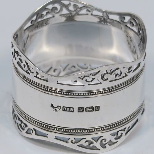 A very pretty Antique Edwardian Sterling Silver pair of napkin rings, having round straight-sided bodies, with hand-pierced scroll borders above two bands of bead work, all in their original dark blue satin and velvet-lined presentation box. These beautiful antique silver napkin rings were made by Roberts and Belk of Sheffield in 1903. The dimensions of these fine hand-made antique silver napkin rings are diameter 4.5 cms (1.75 inches), height 3.5 cms (1.3 inches), and they weigh a total of approx. 52g (1.6 troy ounces).