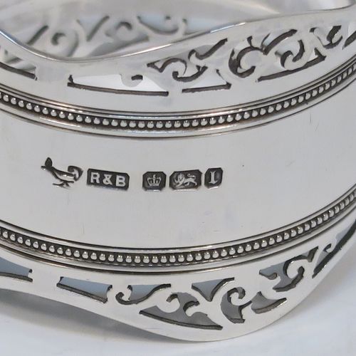 A very pretty Antique Edwardian Sterling Silver pair of napkin rings, having round straight-sided bodies, with hand-pierced scroll borders above two bands of bead work, all in their original dark blue satin and velvet-lined presentation box. These beautiful antique silver napkin rings were made by Roberts and Belk of Sheffield in 1903. The dimensions of these fine hand-made antique silver napkin rings are diameter 4.5 cms (1.75 inches), height 3.5 cms (1.3 inches), and they weigh a total of approx. 52g (1.6 troy ounces).