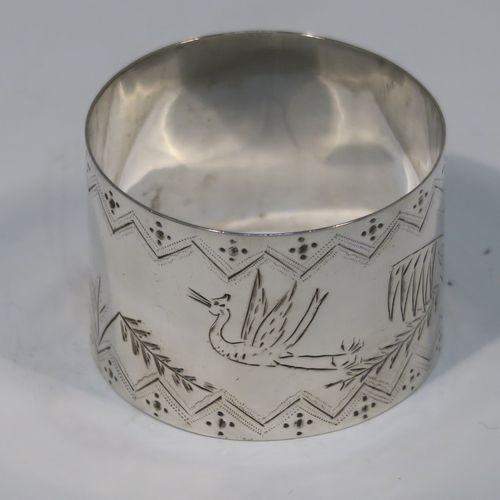 A very pretty pair of Aesthetic style Antique Victorian Sterling Silver napkin rings, having round straight-sided bodies with hand-engraved fern-work decoration and flying crane birds, and all in their original cream satin and black velvet-lined presentation box. These beautiful antique silver Aesthetic style napkin rings were made in London in 1876 and 1877. The dimensions of these fine hand-made antique silver napkin rings are diameter 4 cms (1.5 inches), height 3 cms (1 inch), and they weigh a total of approx. 51g (1.6 troy ounce).   