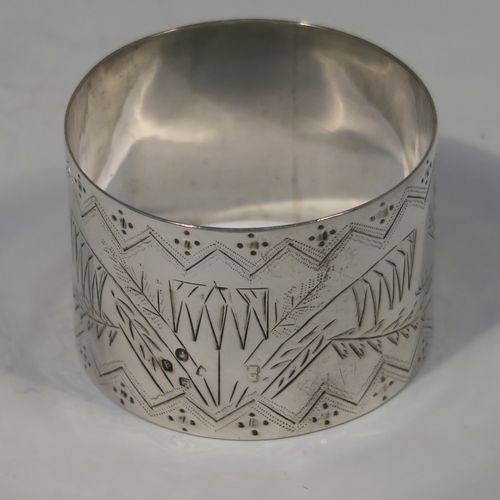 A very pretty pair of Aesthetic style Antique Victorian Sterling Silver napkin rings, having round straight-sided bodies with hand-engraved fern-work decoration and flying crane birds, and all in their original cream satin and black velvet-lined presentation box. These beautiful antique silver Aesthetic style napkin rings were made in London in 1876 and 1877. The dimensions of these fine hand-made antique silver napkin rings are diameter 4 cms (1.5 inches), height 3 cms (1 inch), and they weigh a total of approx. 51g (1.6 troy ounce).   