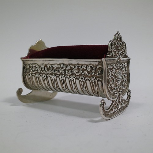 An Antique Victorian Sterling Silver pin cushion, in the form of a babies rocking crib, with hand-chased floral and fluted decoration, together with a maroon velvet covered cushion. Made by Saunders and Shepherd of Birmingham in 1896. The dimensions of this fine hand-made antique silver pin cushion are length 6 cms (2.3 inches), width 3.5 cms (1.3 inches), height 4 cms (1.5 inches), and it weighs approx. 33g (1 troy ounces).   