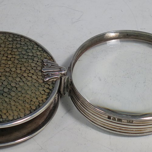 A rare Antique Sterling Silver and Shagreen magnifying glass, having a round body with pull-out and hinged magnifier, with hand-chased reeded borders, and green Shagreen covers. Made by Samuel Jacob of London in 1911. The dimensions of this fine hand-made antique silver and Shagreen magnifying glass and holder are diameter 5 cms (2 inches), length fully unfolded 11 cms (4.3 inches), and depth 1.5 cms (0.5 inch).