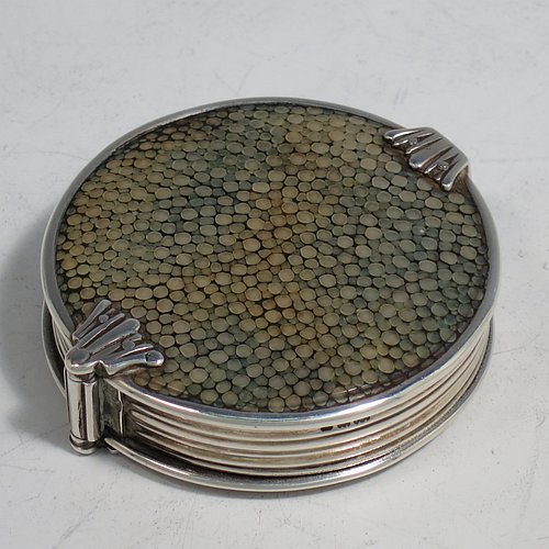 A rare Antique Sterling Silver and Shagreen magnifying glass, having a round body with pull-out and hinged magnifier, with hand-chased reeded borders, and green Shagreen covers. Made by Samuel Jacob of London in 1911. The dimensions of this fine hand-made antique silver and Shagreen magnifying glass and holder are diameter 5 cms (2 inches), length fully unfolded 11 cms (4.3 inches), and depth 1.5 cms (0.5 inch).