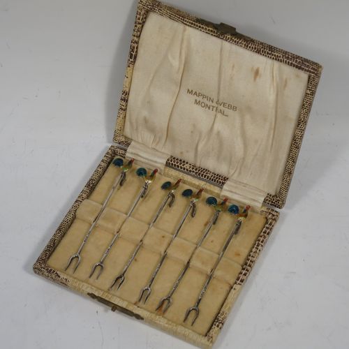 A very stylish Art Deco Sterling silver set of six cocktail sticks, having hand enamelled cockerel mounts and twin toasting fork style ends, all in their original cream satin and velvet-lined presentation box. Made by A. Scott of Birmingham in 1927. The dimensions of this fine hand-made antique silver set of cocktail sticks are length 8.5 cms (3.3 inches), and they weigh a total of approx. 16g (0.5 troy ounces).