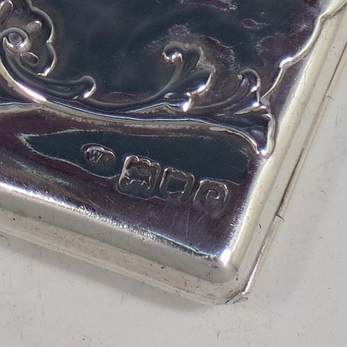 An Antique Victorian Sterling Silver Aide de Memoire and calling card case, having a rectangular body with hand-chased winged cherubs and floral decoration, hinged on one side and with a clasp on the other, and lined with light brown leather pockets. Made by William Comyns of London in 1898. The dimensions of this fine hand-made antique silver Aide de Memoire card case are length 10 cms (4 inches), width 7.5 cms (3 inches), and it weighs approx. 120g (3.9 troy ounces).