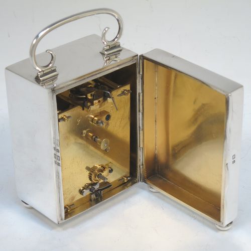 A very handsome Antique Victorian Sterling Silver carriage clock, having a very plain rectangular upright body, with a hinged back door opening to the original clock movement mechanism and winder, a hinged and scrolled top carrying handle, and all sitting on four cushion feet. Made by George Bower of Birmingham in 1900. The dimensions of this fine hand-made antique silver carriage clock are height 9 cms (3.5 inches), width 6.5 cms (2.5 inches), and depth 5 cms (2 inches). Please note that this clock has been serviced and works properly.