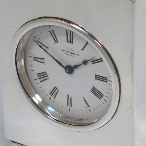 A very handsome Antique Victorian Sterling Silver carriage clock, having a very plain rectangular upright body, with a hinged back door opening to the original clock movement mechanism and winder, a hinged and scrolled top carrying handle, and all sitting on four cushion feet. Made by George Bower of Birmingham in 1900. The dimensions of this fine hand-made antique silver carriage clock are height 9 cms (3.5 inches), width 6.5 cms (2.5 inches), and depth 5 cms (2 inches). Please note that this clock has been serviced and works properly.