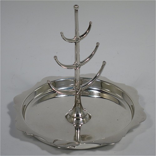 An Antique Sterling Silver ring tree, having a central plain tree for rings attached to a round body with an applied shaped border, and sitting on a flat base. Made by Synter and Beddoes of Birmingham in 1913. The dimensions of this fine hand-made antique silver ring tree are height 10 cms (4 inches), diameter 11 cms (4.25 inches), and it weighs approx. 81g (2.6 troy ounce).    