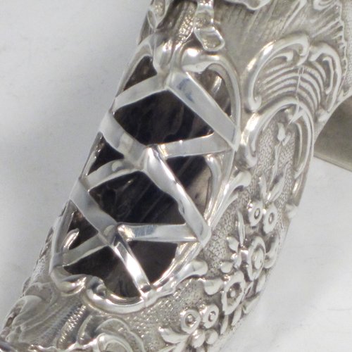 Antique Edwardian sterling silver shoe, having a hand-chased body with floral decoration, with a plain heal, and hand-pierced front laces with a bow. Made by Henry Miller of Birmingham in 1906. The dimensions of this fine hand-made silver shoe are height 5 cms (2 inches), length 11.5 cms (4.5 inches), width 3 cms (1.25 inches), and it weighs approx. 33g (1 troy ounce).