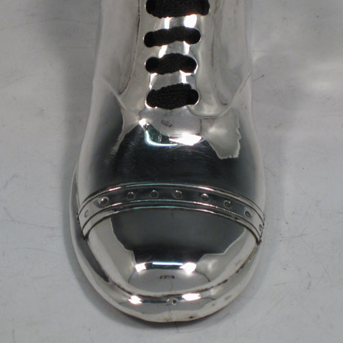 Antique Edwardian sterling silver pin cushion, in the shape of a shoe, having a plain body with laces and an applied decorative band. The dimensions of this fine hand-made silver pin cushion are length 12 cms (4.75 inches), and width 5 cms (2 inches).
