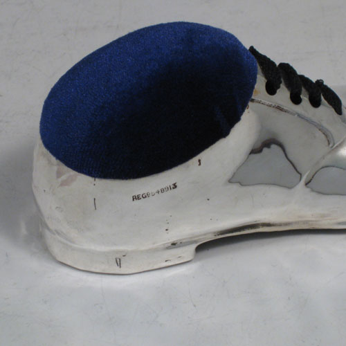 Antique Edwardian sterling silver pin cushion, in the shape of a shoe, having a plain body with laces and an applied decorative band. The dimensions of this fine hand-made silver pin cushion are length 12 cms (4.75 inches), and width 5 cms (2 inches).