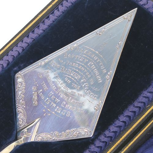 A rare Antique Edwardian Sterling Silver and mother-of-pearl handled ceremonial trowel, the triangular blade having a hand-engraved stone laying inscription for August 15th 1908, in its original dark blue satin and velvet-lined presentation box. This beautiful antique silver trowel was made by Watson and Gillott of Sheffield in 1908. The dimensions of this fine hand-made silver and mother-of-pearl ceremonial trowel length 20cms (8 inches), and width of trowel blade 5.5 cms (2.25 inches).  