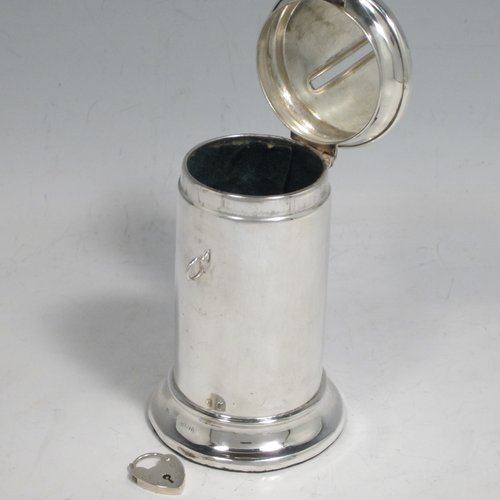 Antique Edwardian sterling silver money box, having a plain round straight-sided body, with hinged money-slot lid, and a hinged clasp with a heart-shaped lock. Made in Birmingham in 1902. The dimensions of this fine hand-made silver money box are height 10 cms (4 inches), diameter at base 6 cms (2.25 inches), and it weighs approx. 95g (3 troy ounces).