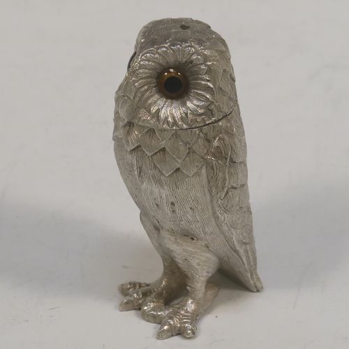 A very pretty pair of cast Sterling Silver Owl salt and pepper shaker pots, having hand-chased barn owl bodies with amber glass eyes and pull-off pierced heads. This beautiful pair of cast sterling silver owl salt and pepper shakers were made by Robert Comyns of London in 1992. The dimensions of this fine hand-made silver pair of owl condiments are height 6 cms (2.3 inches), width 3 cms (1.25 inches), and they weigh a total of approx. 126g (4 troy ounces).   