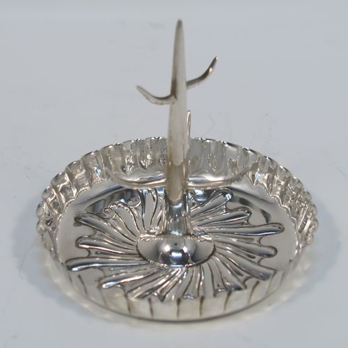 A very pretty Antique Victorian Sterling Silver ring tree, having a central naturalistic tree for rings sitting on a round base with hand-chased swirl-fluted scroll decoration. This beautiful silver ring tree and base was made by Edward Hutton of London in 1893. The dimensions of this fine hand-made antique silver tree ring are height 7 cms (2.75 inches), diameter 8 cms (3.25 inches), and it weighs approx. 44g (1.4 troy ounce).   