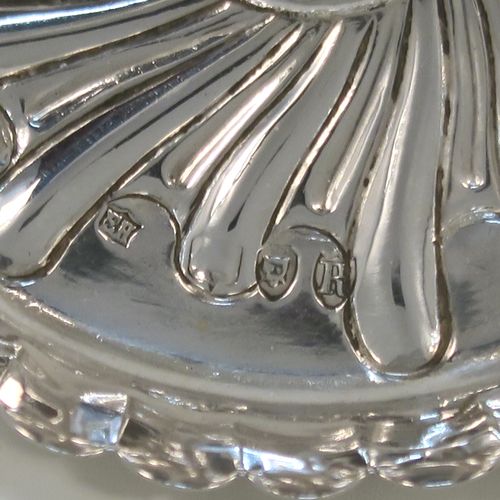 A very pretty Antique Victorian Sterling Silver ring tree, having a central naturalistic tree for rings sitting on a round base with hand-chased swirl-fluted scroll decoration. This beautiful silver ring tree and base was made by Edward Hutton of London in 1893. The dimensions of this fine hand-made antique silver tree ring are height 7 cms (2.75 inches), diameter 8 cms (3.25 inches), and it weighs approx. 44g (1.4 troy ounce).   