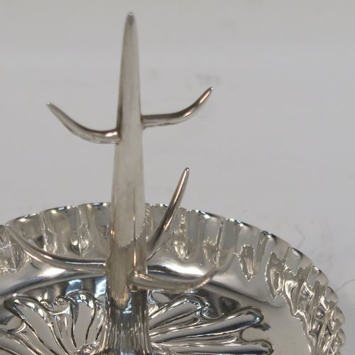 A very pretty Antique Victorian Sterling Silver ring tree, having a central naturalistic tree for rings sitting on a round base with hand-chased swirl-fluted scroll decoration. This beautiful silver ring tree and base was made by Edward Hutton of London in 1893. The dimensions of this fine hand-made antique silver tree ring are height 7 cms (2.75 inches), diameter 8 cms (3.25 inches), and it weighs approx. 44g (1.4 troy ounce).   