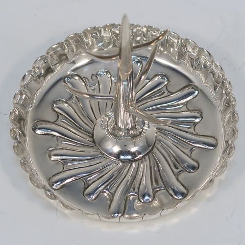 A very pretty Antique Victorian Sterling Silver ring tree, having a central naturalistic tree for rings sitting on a round base with hand-chased swirl-fluted scroll decoration. This beautiful silver ring tree and base was made by Edward Hutton of London in 1893. The dimensions of this fine hand-made antique silver tree ring are height 7 cms (2.75 inches), diameter 8 cms (3.25 inches), and it weighs approx. 44g (1.4 troy ounce).   