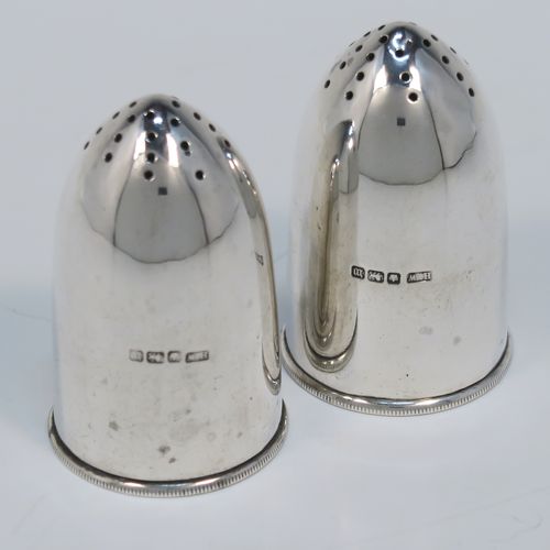 A very rare and handsome pair of Antique Sterling Silver Bullet case or cartridge pepper pots, having plain round bodies with pull-off Primer style flat bases. This elegant pair of silver Bullet style pepper pots were made on the eve of the First World War by Henry Wilkinson of Sheffield in 1914. The dimensions of this rare pair of Cartridge or Bullet pepper shakers are height 6 cms (2.25 inches), diameter at base 3.5 cms (1.3 inches), and they weigh a total of approx. 66g (2 troy ounce).   