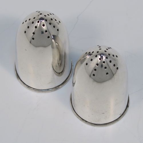 A very rare and handsome pair of Antique Sterling Silver Bullet case or cartridge pepper pots, having plain round bodies with pull-off Primer style flat bases. This elegant pair of silver Bullet style pepper pots were made on the eve of the First World War by Henry Wilkinson of Sheffield in 1914. The dimensions of this rare pair of Cartridge or Bullet pepper shakers are height 6 cms (2.25 inches), diameter at base 3.5 cms (1.3 inches), and they weigh a total of approx. 66g (2 troy ounce).