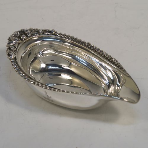 A handsome Antique Georgian Sterling Silver pap boat, in a Regency style having an applied cast gadroon, oak-leaf, and shell upper border, attached to a very plain oval body with a flat base. This elegant antique silver pap boat was made by the Barnard Brothers of London in 1835. The dimensions of this fine hand-made antique silver pap boat are length 13.5 cms (5.25 inches), width 7.5 cms (3 inches), and it weighs approx. 78g (2.5 troy ounces).
