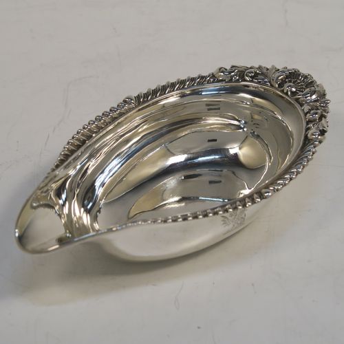 A handsome Antique Georgian Sterling Silver pap boat, in a Regency style having an applied cast gadroon, oak-leaf, and shell upper border, attached to a very plain oval body with a flat base. This elegant antique silver pap boat was made by the Barnard Brothers of London in 1835. The dimensions of this fine hand-made antique silver pap boat are length 13.5 cms (5.25 inches), width 7.5 cms (3 inches), and it weighs approx. 78g (2.5 troy ounces).