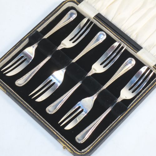 A very pretty Sterling Silver set of six pastry forks, having single-struck pearl and bead handles, and three tined forks, all in their original cream satin and black velvet-lined presentation box. Made by Emile Viner of Sheffield in 1932. The dimensions of these fine hand-made silver pastry forks are length 12.5 cms (5 inches), and they weigh a total of 99g (3.2 troy ounces).