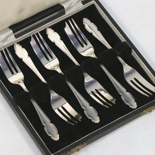 A very handsome Sterling Silver set of six pastry forks, having Chippendale or Dubarry pattern handles, and three tined forks, all in their original cream satin and black velvet-lined presentation box. Made by the Cooper Brothers of Sheffield in 1935. The dimensions of these fine hand-made silver pastry forks are length 13 cms (5.25 inches), and they weigh a total of 132g (4.3 troy ounces). Please note that the box is in good overall condition, and the lid closes properly, but the whole box is slightly warped.