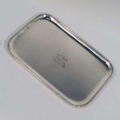 A very handsome Antique Georgian Sterling Silver pen tray, having a very plain rectangular body with rounded corners and an applied reeded border, and all sitting on a flat base. This elegant antique silver pen tray was made by John Mewburn of London in 1792. The dimensions of this fine hand-made antique silver pen tray are length 23 cms (9 inches), width 15 cms (6 inches), and it weighs approx. 276g (9 troy ounces). Please note that this item is crested.
