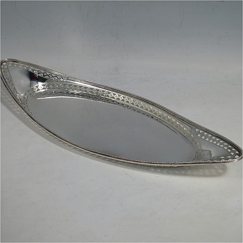A very pretty Antique Victorian Sterling Silver pen tray, having an oval body, an applied bead border with bands of hand-engraved and hand-pierced geometrical decoration, and sitting on a flat base. Made by Charles Stuart Harris of London in 1899. The dimensions of this fine hand-made antique silver pen tray are length 27 cms (10.5 inches), width 10 cms (4 inches), and it weighs approx. 137g (4.4 troy ounces).