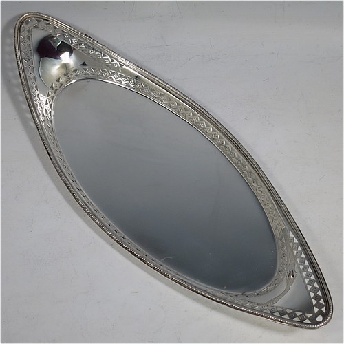 A very pretty Antique Victorian Sterling Silver pen tray, having an oval body, an applied bead border with bands of hand-engraved and hand-pierced geometrical decoration, and sitting on a flat base. Made by Charles Stuart Harris of London in 1899. The dimensions of this fine hand-made antique silver pen tray are length 27 cms (10.5 inches), width 10 cms (4 inches), and it weighs approx. 137g (4.4 troy ounces).