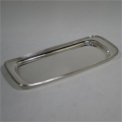 A very handsome Antique Victorian Sterling Silver pen tray, having a rectangular body with raised edge and rounded corners, an applied reeded border, and a plain ground, sitting on a flat base. Made by Charles Stuart Harris of London in 1895. The dimensions of this fine hand-made antique silver pen tray are length 21.5 cms (8.5 inches), width 9.5 cms (3.75 inches), and it weighs approx. 150g (4.8 troy ounces).    
