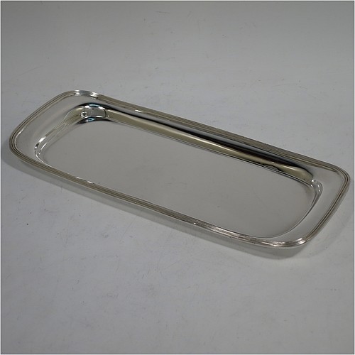 A very handsome Antique Victorian Sterling Silver pen tray, having a rectangular body with raised edge and rounded corners, an applied reeded border, and a plain ground, sitting on a flat base. Made by Charles Stuart Harris of London in 1895. The dimensions of this fine hand-made antique silver pen tray are length 21.5 cms (8.5 inches), width 9.5 cms (3.75 inches), and it weighs approx. 150g (4.8 troy ounces).