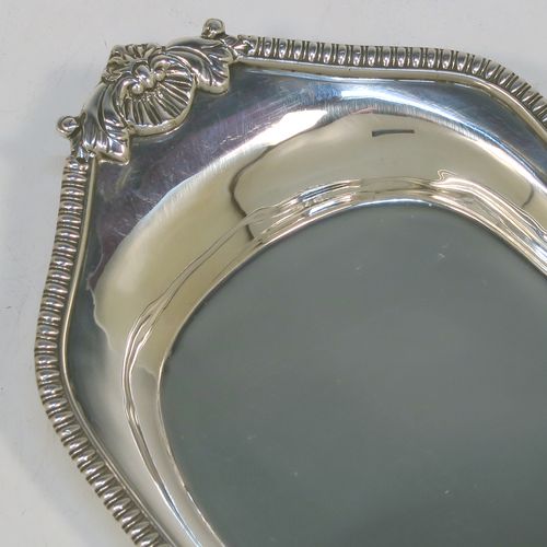 A very handsome Antique Georgian Sterling Silver pen tray, having a shaped rectangular body, with a plain flat ground, applied gadroon borders and cast shells at either end, and all sitting on a flat base. This beautiful antique silver pen tray was made in London in 1814. The dimensions of this fine hand-made antique silver pen tray are length 24 cms (9.5 inches), width 10 cms (4 inches), and it weighs approx. 140g (4.5 troy ounces).