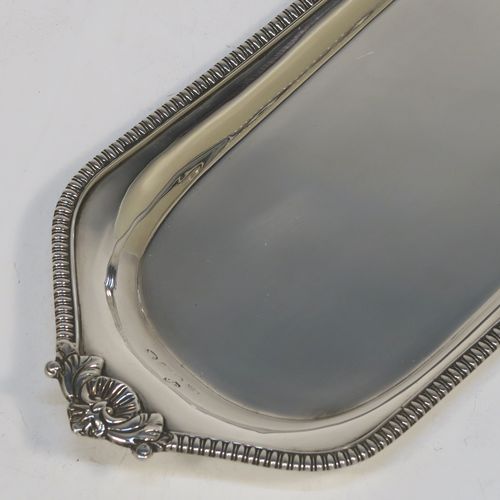 A very handsome Antique Georgian Sterling Silver pen tray, having a shaped rectangular body, with a plain flat ground, applied gadroon borders and cast shells at either end, and all sitting on a flat base. This beautiful antique silver pen tray was made in London in 1814. The dimensions of this fine hand-made antique silver pen tray are length 24 cms (9.5 inches), width 10 cms (4 inches), and it weighs approx. 140g (4.5 troy ounces).