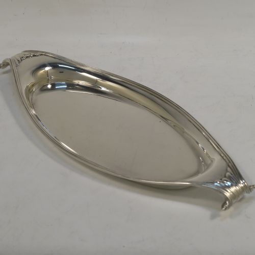 A very elegant Antique Victorian Sterling Silver pen tray, having a very plain oval body with applied reeded borders, cast scrolled handles at either end, and all sitting on a flat base. This beautiful antique silver pen tray was made by D. and J. Welby of London in 1893. The dimensions of this fine hand-made antique silver pen tray are length 23 cms (9 inches), width 10 cms (4 inches), and it weighs approx. 152g (4.9 troy ounces).