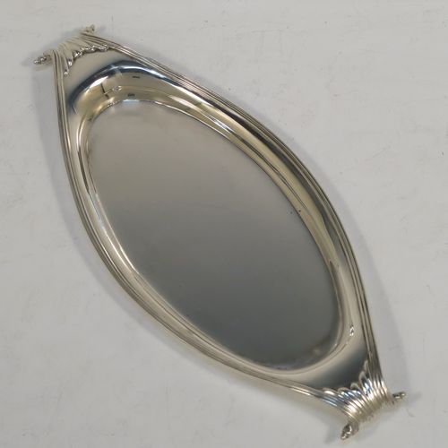 A very elegant Antique Victorian Sterling Silver pen tray, having a very plain oval body with applied reeded borders, cast scrolled handles at either end, and all sitting on a flat base. This beautiful antique silver pen tray was made by D. and J. Welby of London in 1893. The dimensions of this fine hand-made antique silver pen tray are length 23 cms (9 inches), width 10 cms (4 inches), and it weighs approx. 152g (4.9 troy ounces).