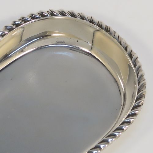 A handsome Antique Sterling Silver pen tray, having a rectangular body with rounded ends, an applied gadroon border, and all sitting on a flat base. This elegant silver pen tray was made by Stokes and Ireland of London in 1912. The dimensions of this fine hand-made silver pen tray are length 22.5 cms (8.75 inches), width 6 cms (2.3 inches), and it weighs approx. 97g (3 troy ounces).