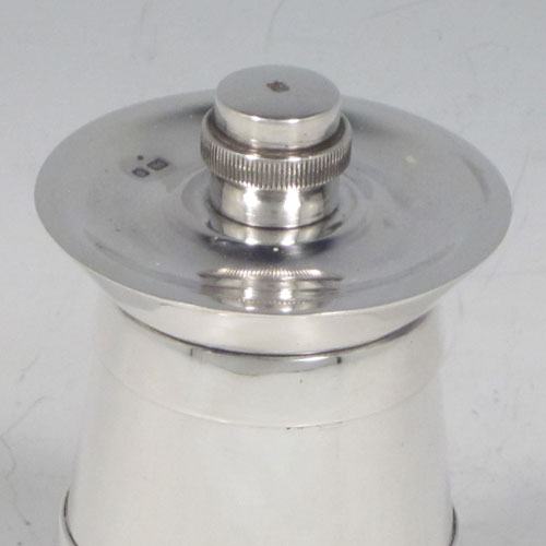 Sterling silver pair of pepper grinders, having plain tapering straight sided bodies with three applied bands, with knurled grinder finials, and both having good quality grinder mechanisms that work properly. Made by Collett and Anderson of London in 1954. The dimensions of these fine hand-made silver pepper grinders are height 8 cms (3 inches), and diameter at base 4.5 cms (1.75 inches).