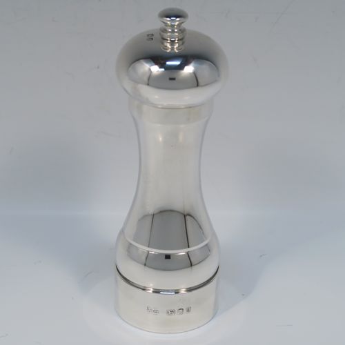 A large and handsome Sterling Silver pepper grinder, having a plain round baluster body, an original Peter Piper grinder mechanism, and a plain round finial. This elegant silver pepper grinder was made by W.E.V. of London in 1986. The dimensions of this fine hand-made silver pepper grinder are height 15 cms (6 inches), diameter at base 5 cms (2 inches), and it weighs approx. 185g (6 troy ounces).   